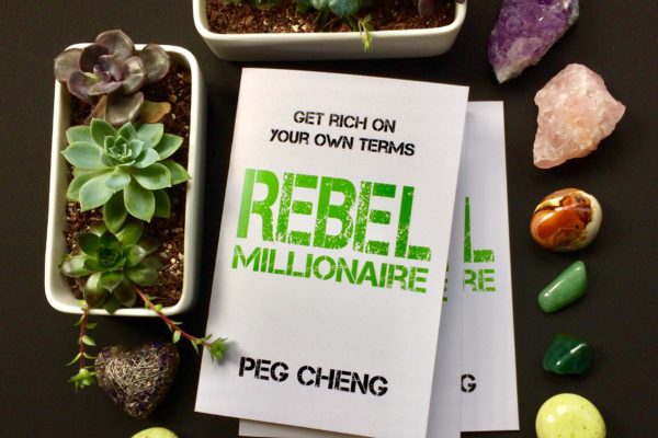Rebel Millionaire by Peg Cheng surrounded by crystals and succulents